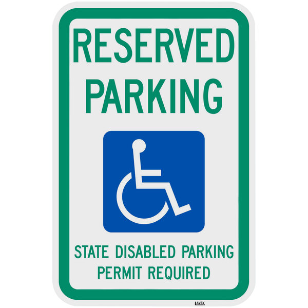 A green and blue aluminum parking lot sign that says "Reserved Parking State Disabled Parking Permit Required" with a white wheelchair symbol.