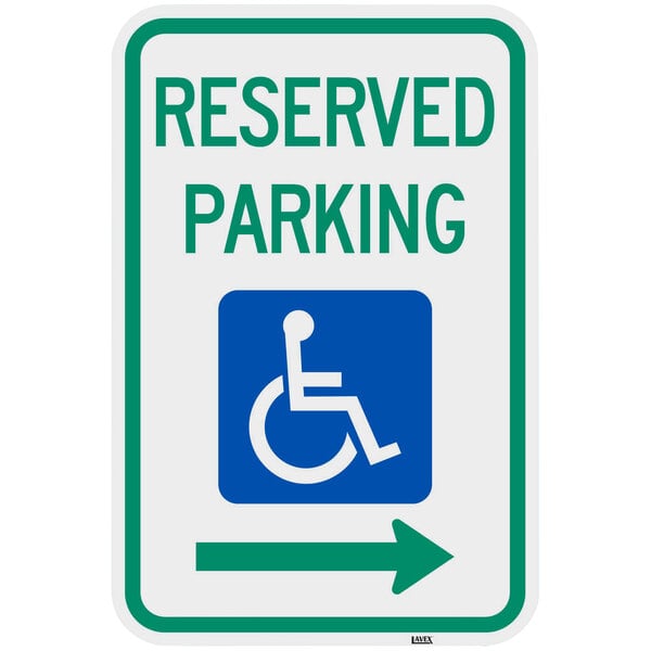 A green and white aluminum parking sign with a wheelchair and "Handicapped Reserved Parking" and a right arrow.