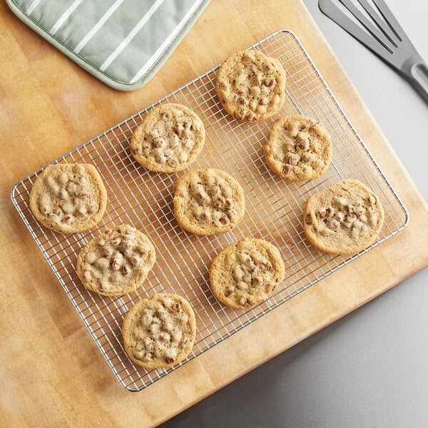 A Baker's Mark stainless steel wire cooling rack with cookies on it.