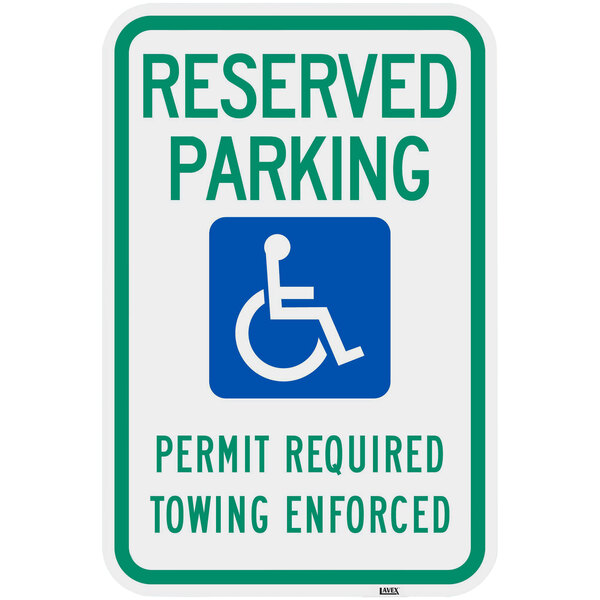 A green and blue aluminum parking sign that says "Handicapped Reserved Parking / Permit Required / Towing Enforced" with white text and symbols.