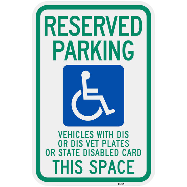 A green and blue Lavex aluminum parking sign with a wheelchair symbol and text that reads "Handicapped Reserved Parking / Vehicles With Dis Or Dis Vet Plates"
