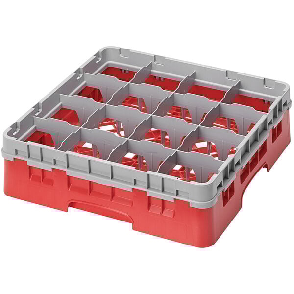 A red and grey plastic Cambro glass rack with 16 compartments.