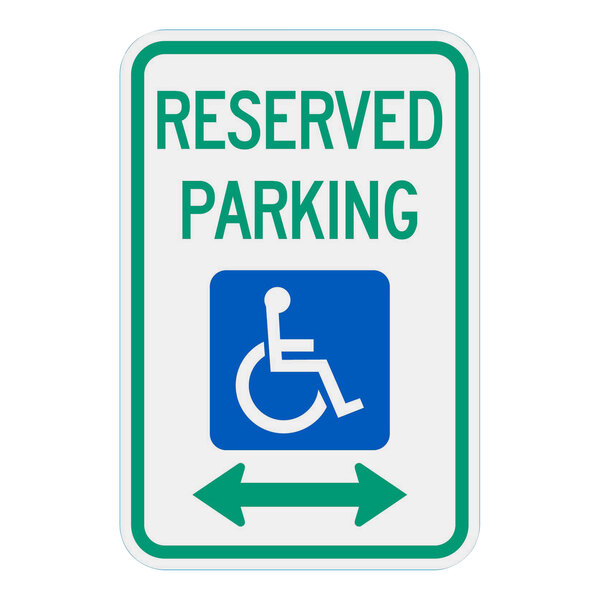 A green and white aluminum sign with a wheelchair symbol and an arrow pointing to the right.