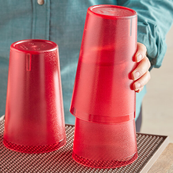 A person holding a red plastic cup.