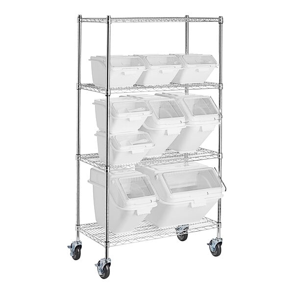 A group of white bins on a metal rack.