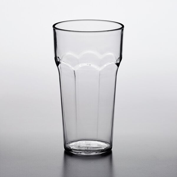 A clear plastic paneled tumbler on a white surface.