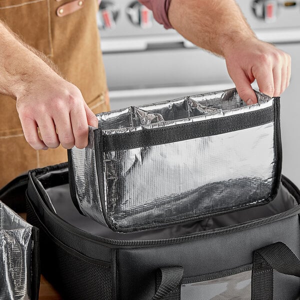 A person using a ServIt replacement drink holder on a delivery bag with a zipper.