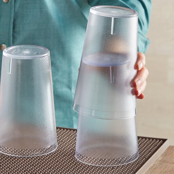 A person holding a plastic cup.