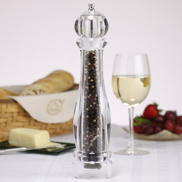 A Chef Specialties Ultima acrylic pepper mill with black and white peppercorns in it.
