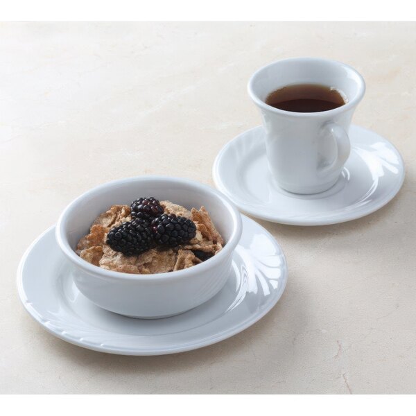 A Tuxton bright white china bowl filled with cereal and blackberries on a white background.