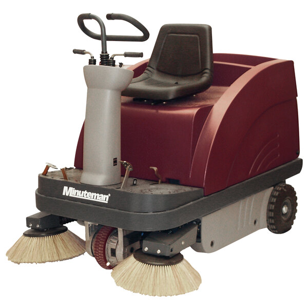 A red and white Minuteman floor sweeper with a chair on it.
