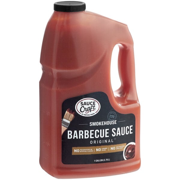 A case of four 1-gallon bottles of Sauce Craft Original BBQ Sauce on a counter.