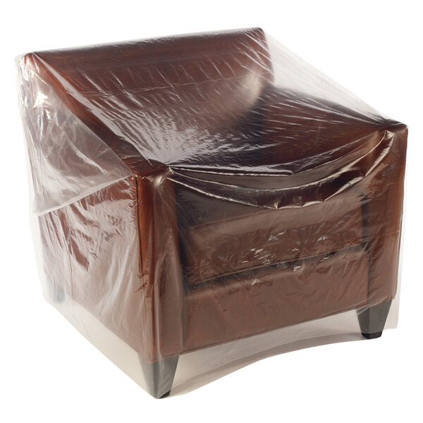 A brown chair covered in a Lavex clear plastic chair bag.