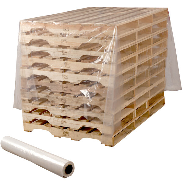 A stack of wooden pallets covered in clear plastic using a roll of Lavex plastic sheeting.