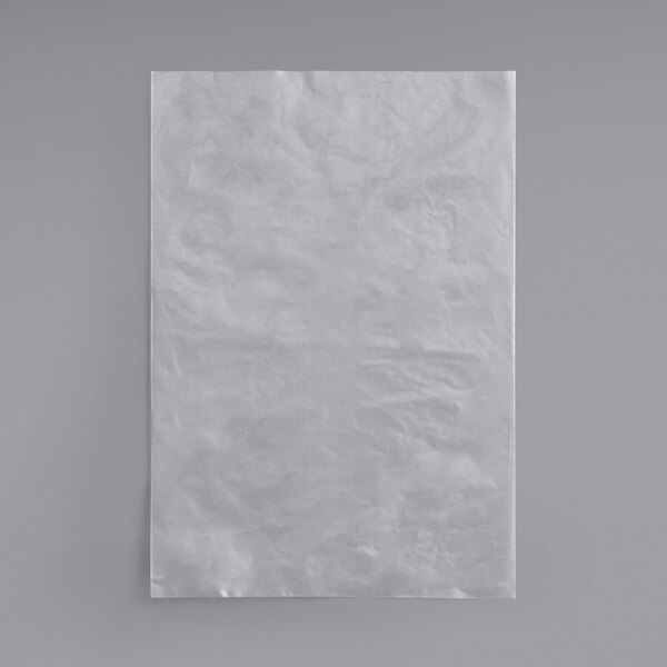A white paper bag on a gray surface.