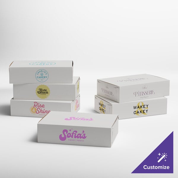 A set of white customizable bakery boxes with various printed logos and designs.
