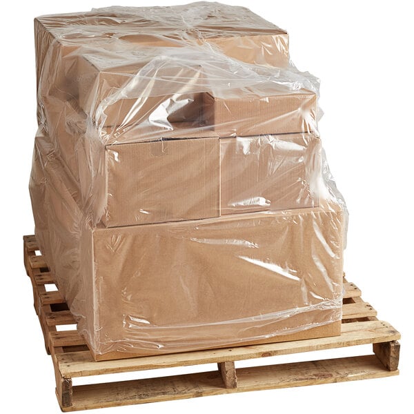 A pallet with boxes wrapped in clear plastic using a Lavex pallet cover.