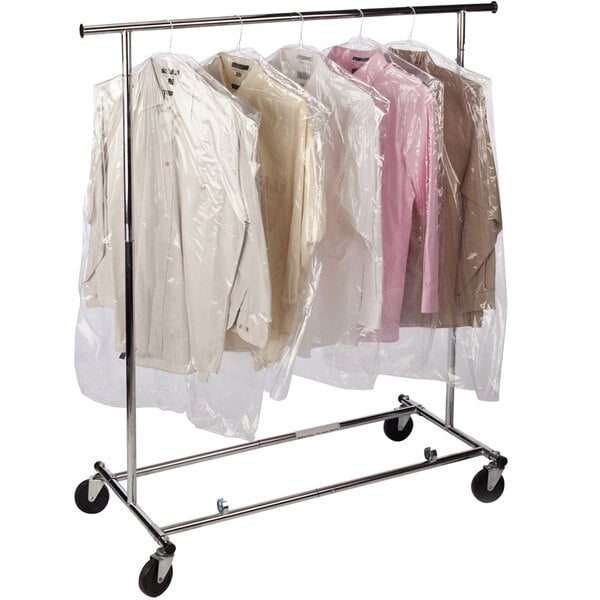 A Lavex clear polyethylene garment bag on a roll holding clothes