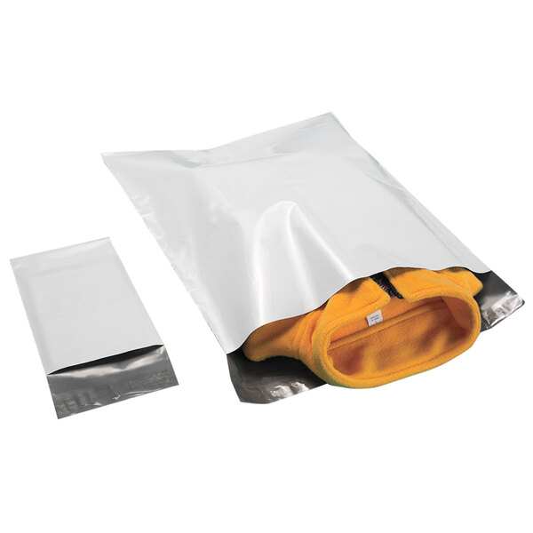 A white plastic bag with a black strip and tamper-evident adhesive closure containing a Lavex white polyethylene mailer.