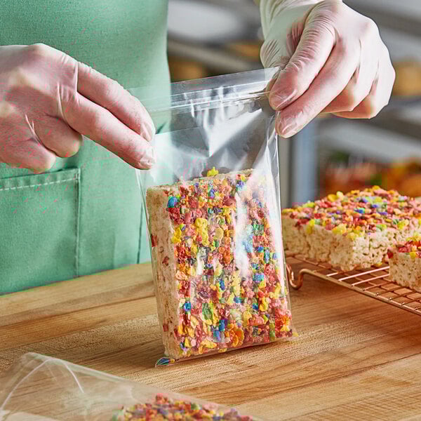 A person holding a Choice plastic resealable bag of colorful cereal.