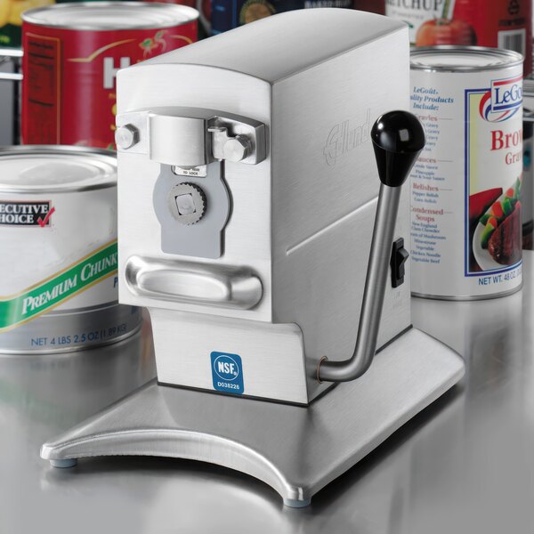 An Edlund heavy-duty electric can opener next to cans of food.