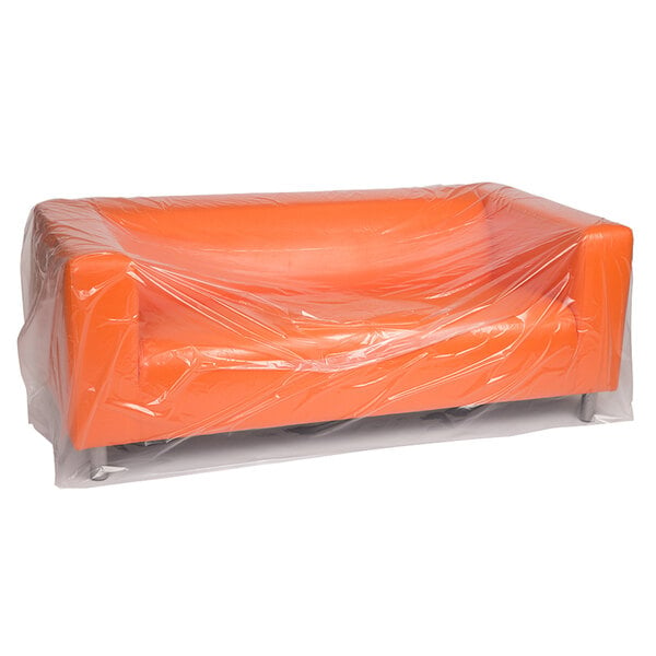 A clear plastic furniture bag covering an orange couch.