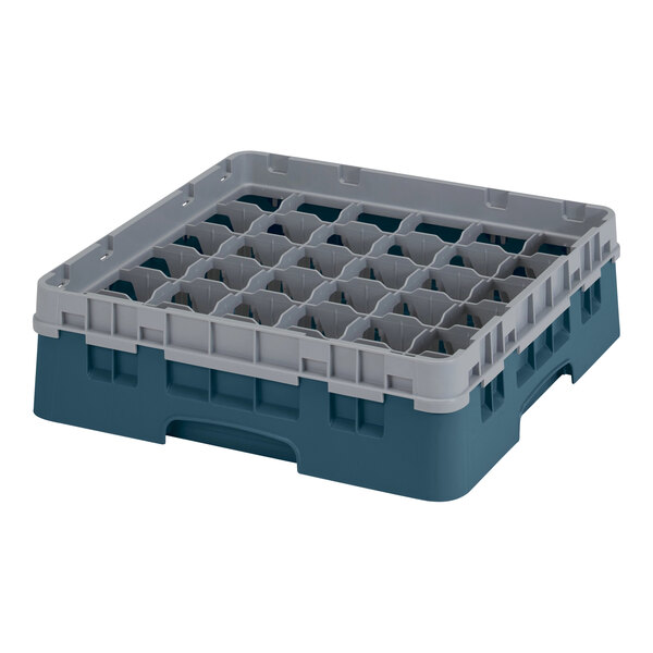 A teal plastic Cambro glass rack with many compartments and holes.