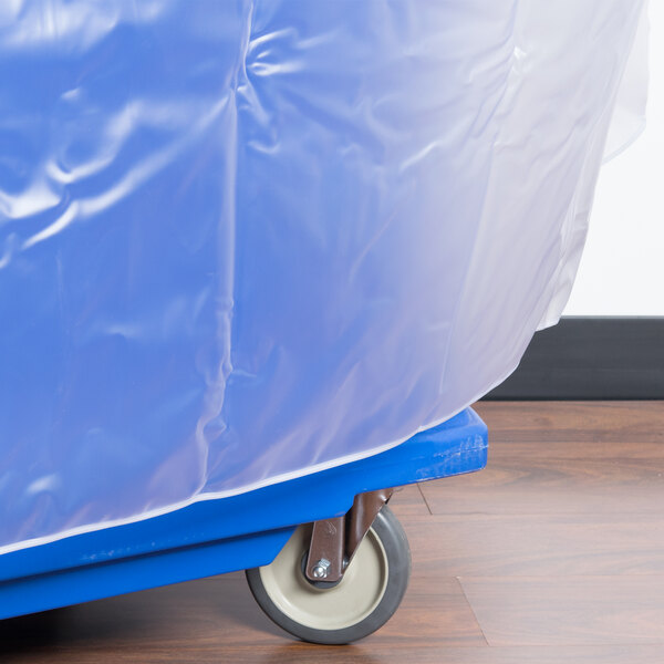 A blue plastic cover on a Cambro food bar cart with wheels.
