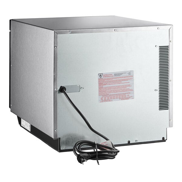 A silver stainless steel Amana commercial microwave with a black cord.