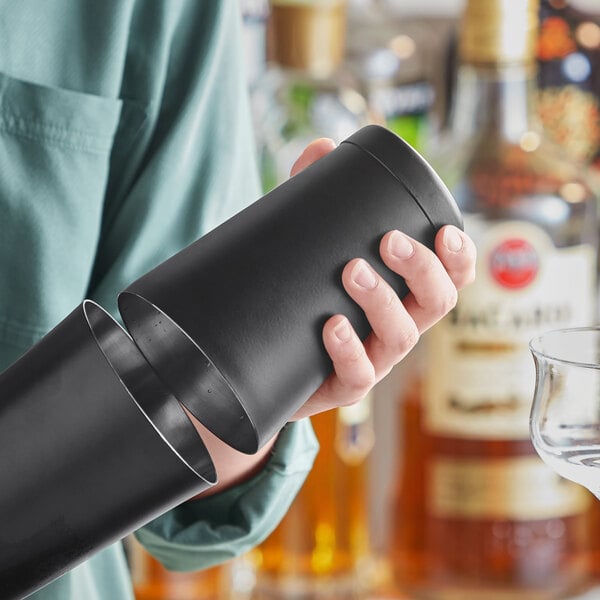 A person holding a black Acopa cocktail shaker.