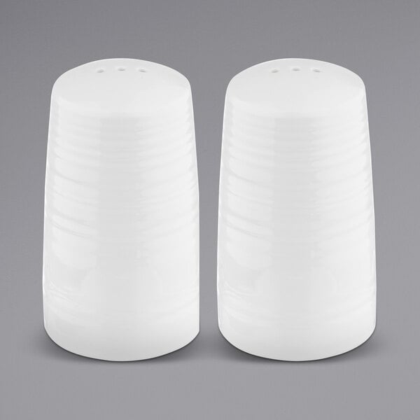 Two white Tablecraft salt and pepper shakers.