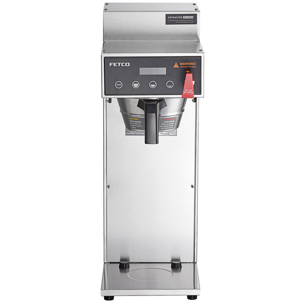 A Fetco airpot coffee brewer with a stainless steel base and black accents.