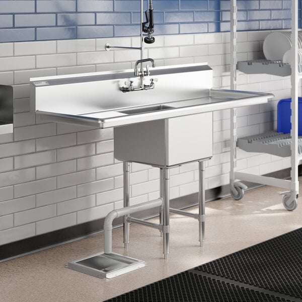 A Regency stainless steel one compartment sink with drainboards and a faucet over a shelf.