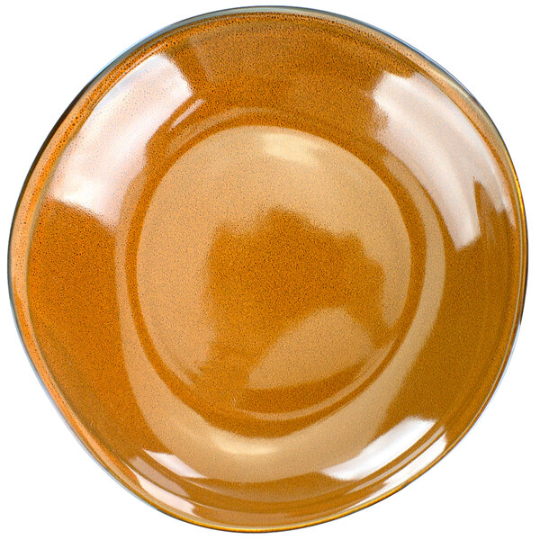 A close up of a terracotta porcelain bowl with a white background.