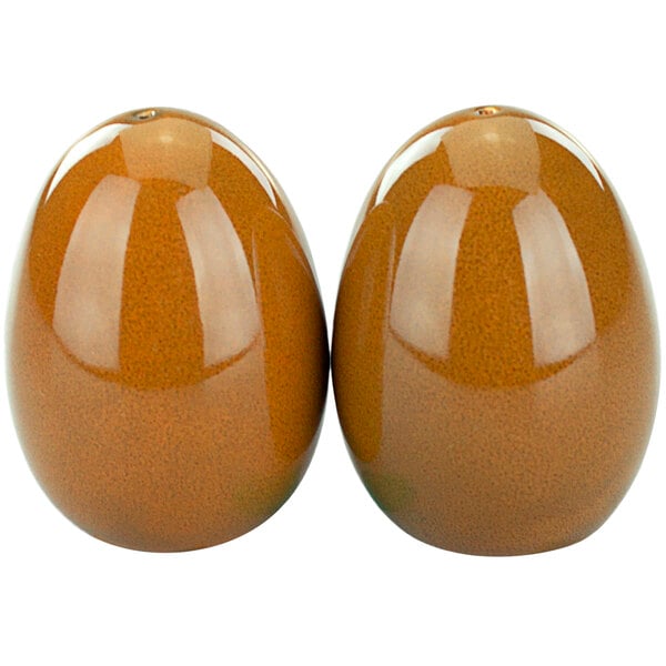 Two brown terracotta porcelain salt and pepper shakers.