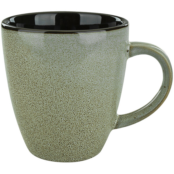 A white International Tableware porcelain mug with a black rim and gray speckles.