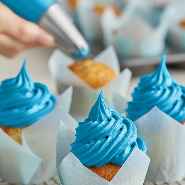 A close up of blue frosting on cupcakes made with Chefmaster Sky Blue Liqua-Gel Food Coloring.