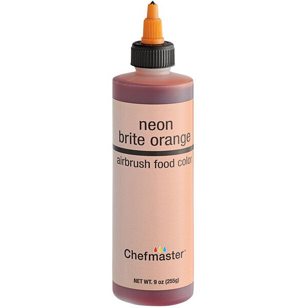 A close-up of a bottle of Chefmaster neon brite orange food coloring.