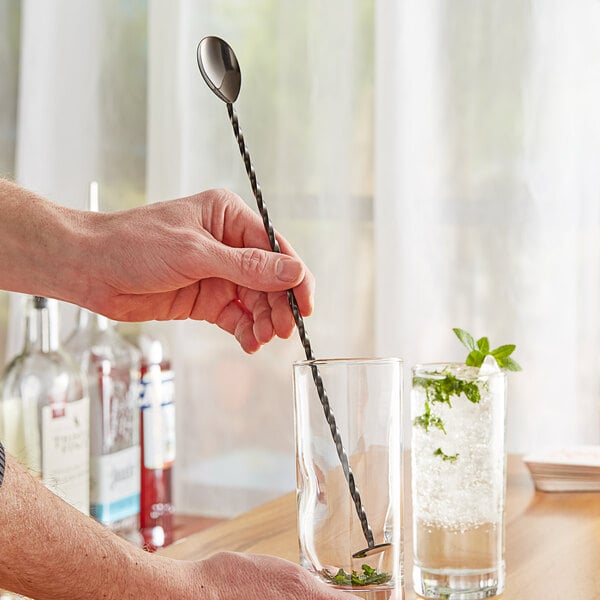 a person holding a straw in a glass