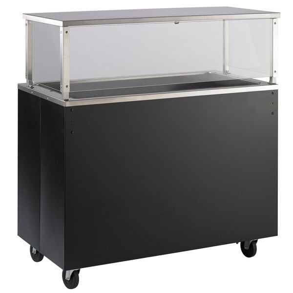 A black and silver food cart with a clear glass top on a counter.