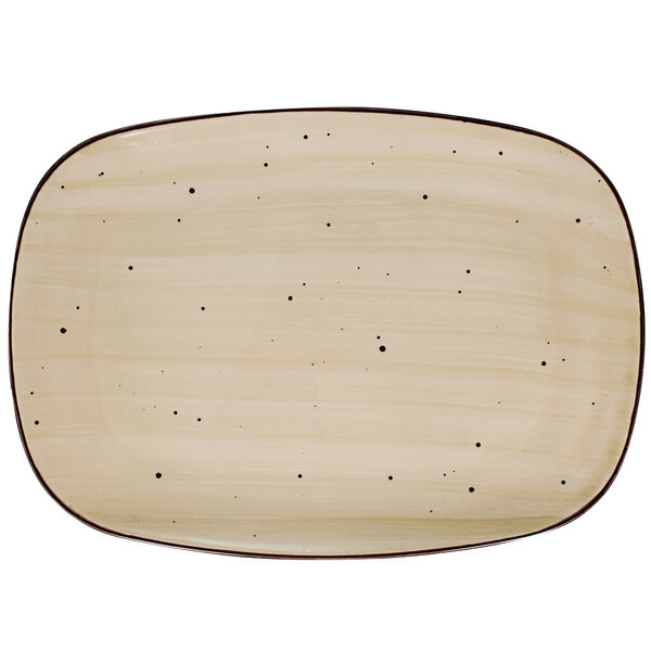 A white rectangular porcelain platter with black dots.