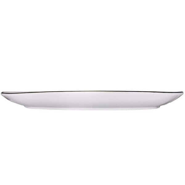 A white International Tableware rectangular porcelain platter with a silver rim.