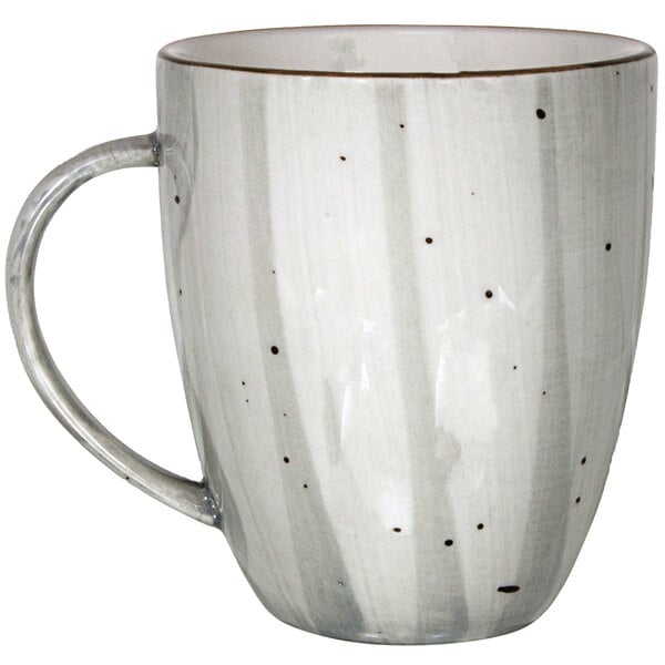 a white and grey mug with black dots