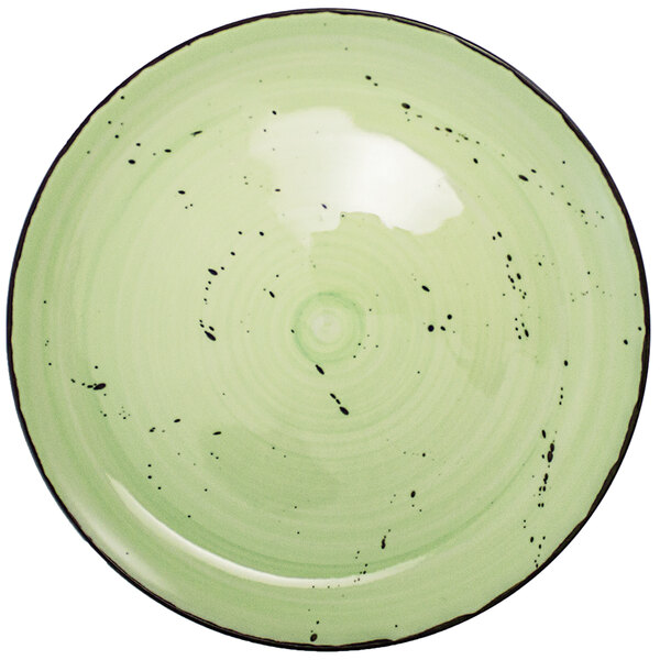 An International Tableware lime green porcelain plate with black specks.