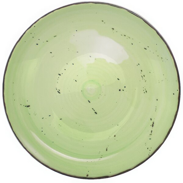 A lime green porcelain bowl with black specks.