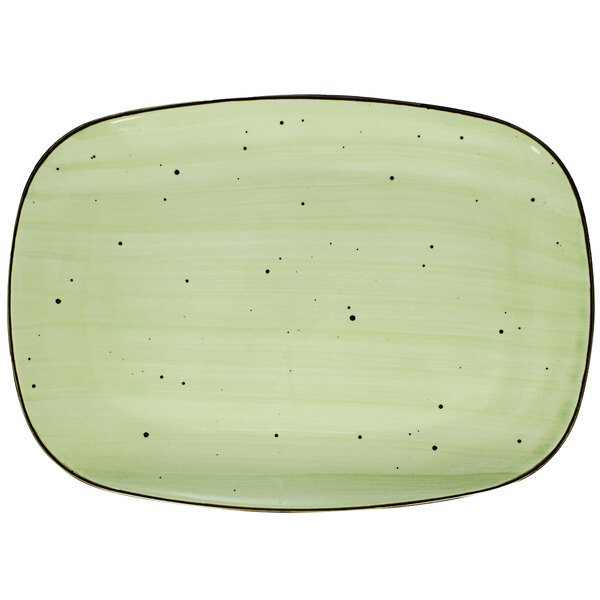 A lime green rectangular porcelain platter with black specks.