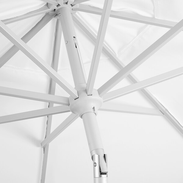 A white umbrella with a metal pole.
