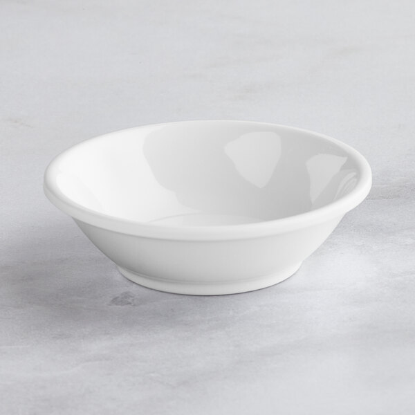 a white bowl on a marble surface