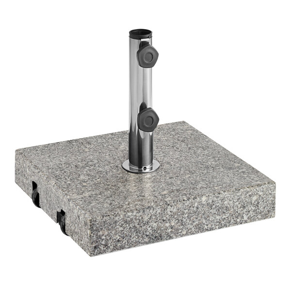 A metal pole in a square grey stone surface with a Lancaster Table & Seating Gray Granite Umbrella Base.