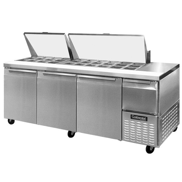 A Continental Refrigerator stainless steel food prep table with three trays.